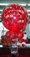 Valentine’s Day balloon bouquet with red and pink mylar balloons reading “I Love You,” paired with a 1lb bag of Hershey’s Kisses