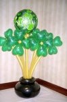 Large St. Patrick’s Day balloon bouquet with shamrock and green gold balloons on a festive green base