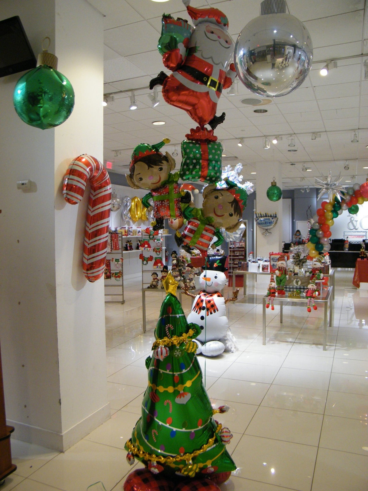 Christmas tree balloon bouquet with Santa and elf Mylar balloons, festive holiday airwalker display