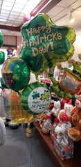Close-up of St. Patrick’s Day balloon bouquet with decorative weight and festive balloons